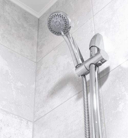 Rain shower in modern bathroom, modern interior apartment design photo in bright white colors